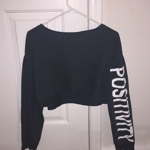 Divided Tops - Green crop top with positivity on the left sleeve.